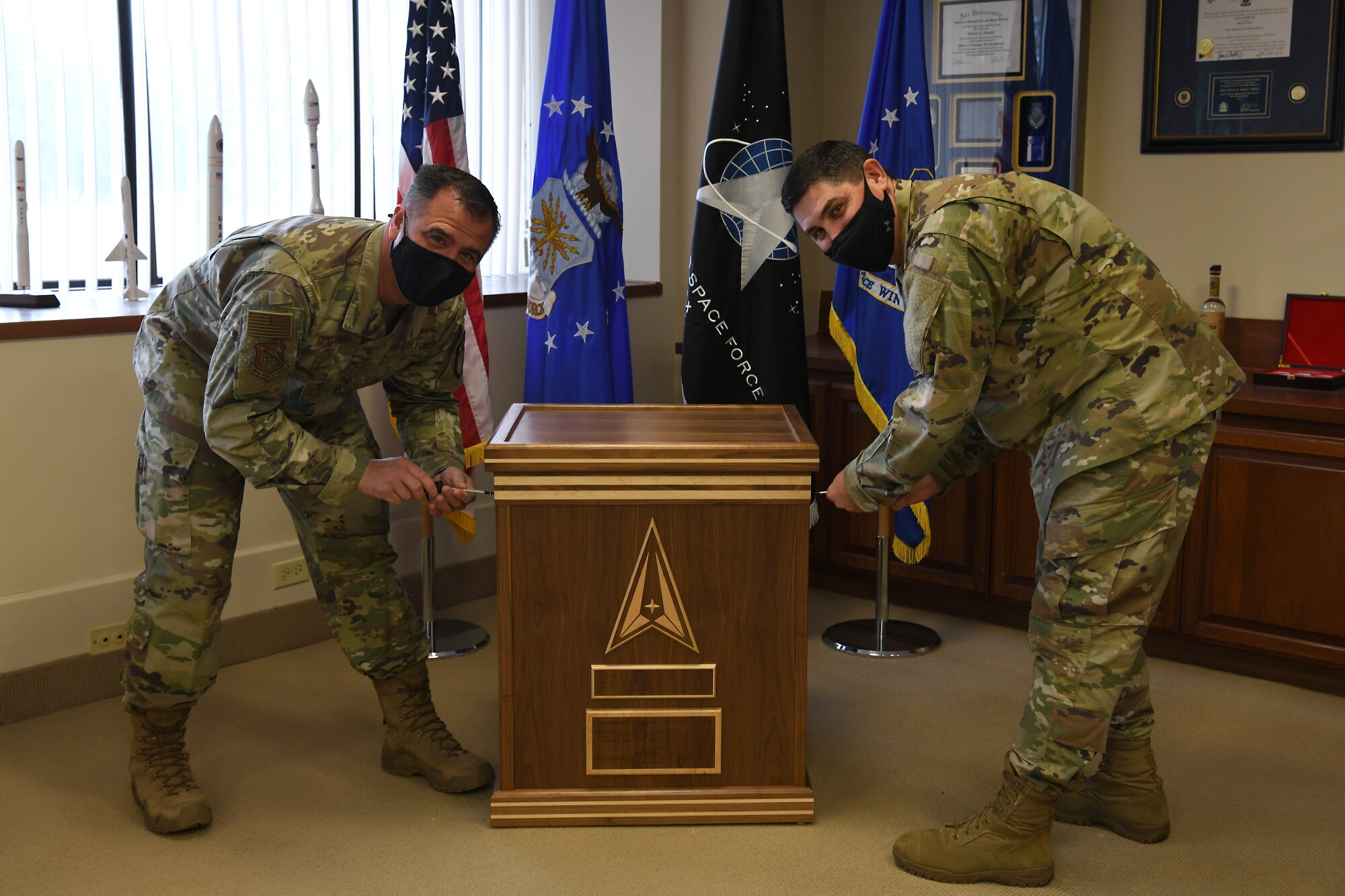 Col. Anthony Mastalir, 30th Space Wing commander, and Chief Master Sgt. Jason DeLucy, 30th SW command chief, close the 30th Space Wing 2020 time capsule in celebration of the one year anniversary of the U.S. Space Force Dec. 17, 2020, at Vandenberg Air Force Base, Calif.