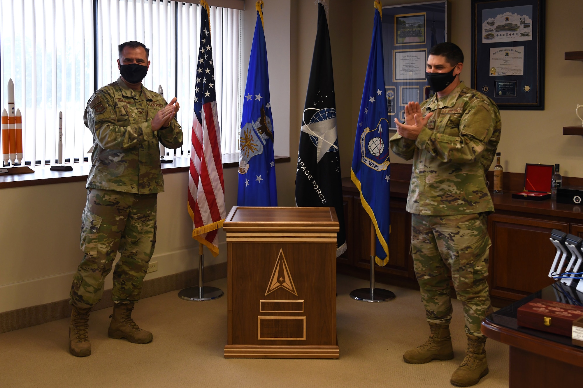 Col. Anthony Mastalir, 30th Space Wing commander, and Chief Master Sgt. Jason DeLucy, 30th SW command chief, cheer after closing the 30th Space Wing 2020 time capsule in celebration of the one year anniversary of the U.S. Space Force Dec. 17, 2020, at Vandenberg Air Force Base, Calif.