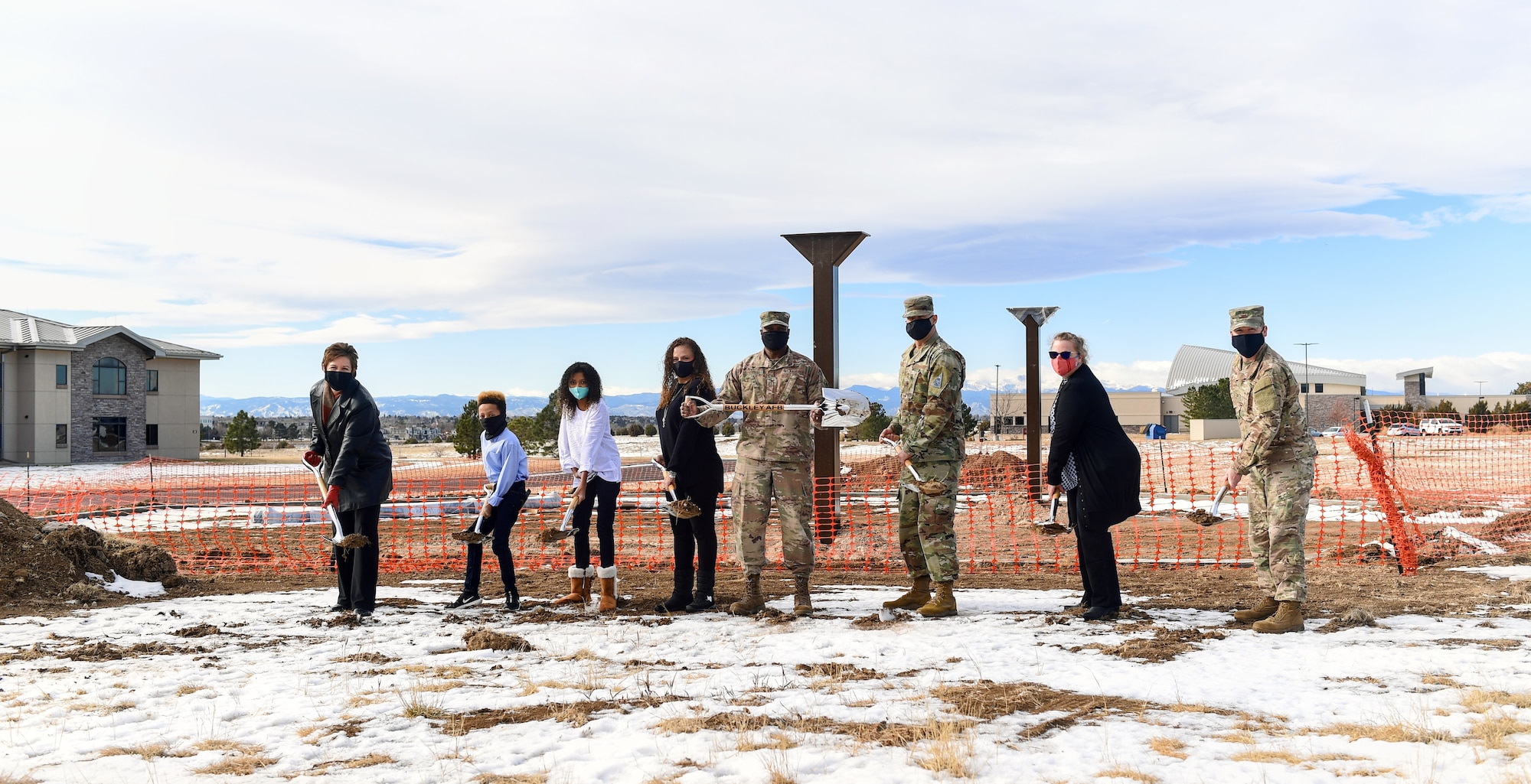 From left to right, Debbie Southee, 460th Force Support Squadron civilian leader, Luke and Madi Pepper, Alicia Pepper, Col. Devin Pepper, Buckley Garrison commander, Chief Master Sgt. Robert Devall, BGAR command chief, Jenny Meadlin, 460th Contracting Squadron contracting officer, and Col. Brian Chellgren, 460th Mission Support Group commander, dig their shovels into the soil outside of the construction site for Buckley Garrison’s Community Playground near Rocky Mountain Lodge during the groundbreaking ceremony on Buckley Air Force Base, Co., Dec. 21, 2020.