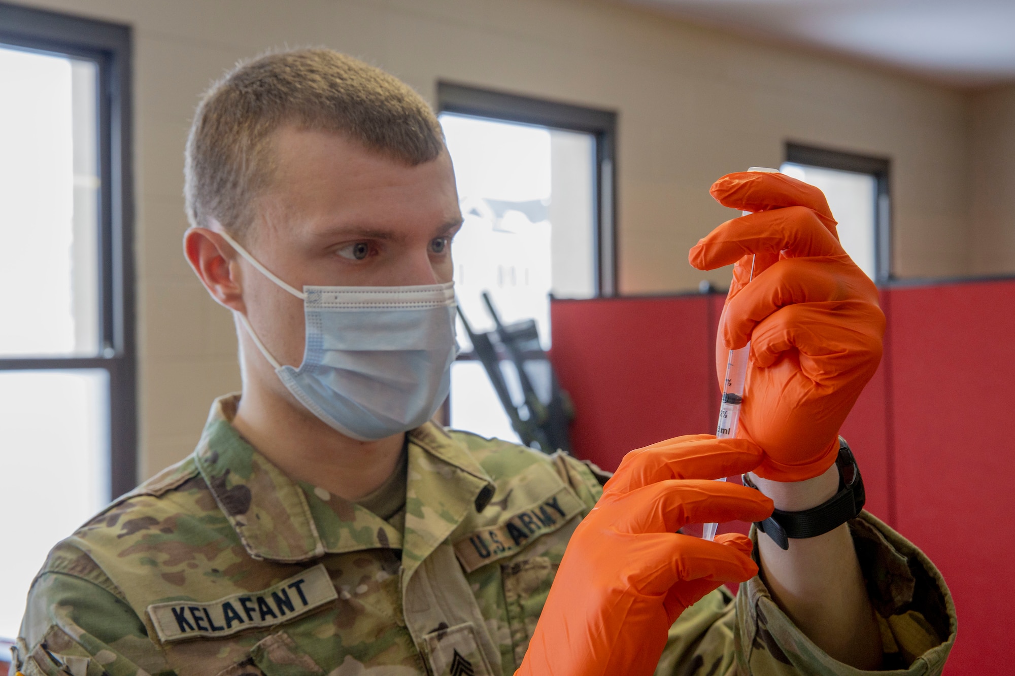 U.S. Army Sgt. Tyler Kelfant, assigned to Joint Task Force COVID-19, New York National Guard, prepares a dose of the Pfizer-BioNTech COVID-19 vaccine at the Camp Smith Training Site Medical Readiness Clinic, N.Y., on Dec. 18, 2020. The New York National Guard is participating in a Department of Defense vaccine pilot program in which 44,000 doses of the Pfizer vaccine are being administered to frontline medical personnel at 16 locations around the world.