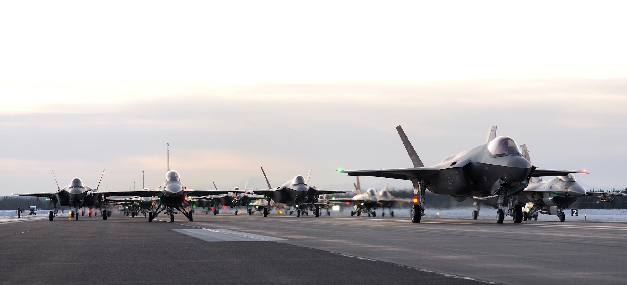Eighteen U.S. Air Force F-35A Lightning IIs and 12 F-16 Fighting Falcons assigned to the 354th Fighter Wing and two KC-135 Stratotankers assigned to the 168th Wing form an elephant walk on Eielson Air Force Base, Alaska, Dec. 18, 2020.