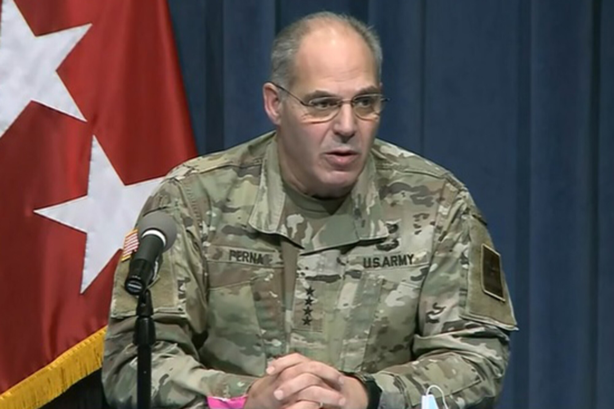 A military officer speaks to reporters.