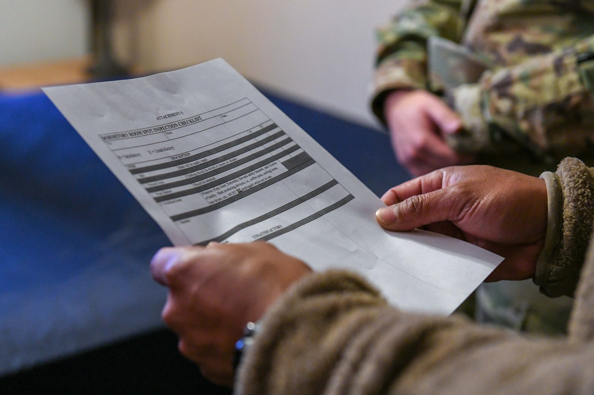 An Airman looks at a piece of paper.