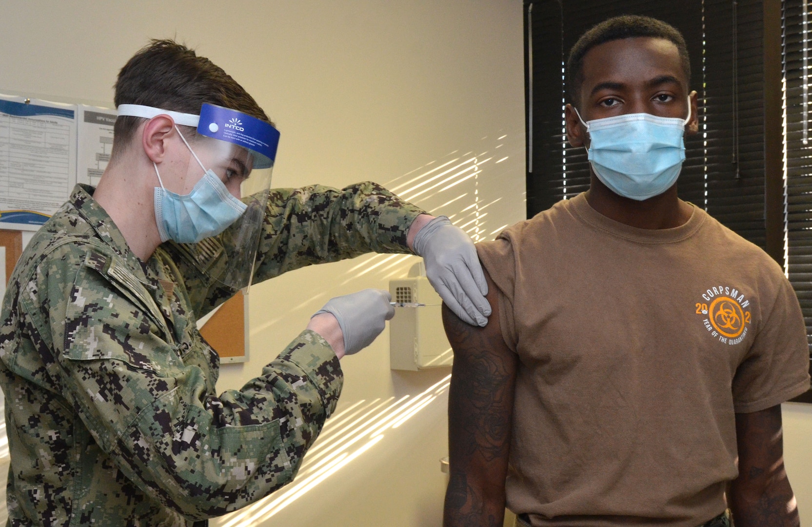 Hospital Corpsman 2nd Class Jamelle James receives a COVID-19 vaccine at Naval Hospital Jacksonville.