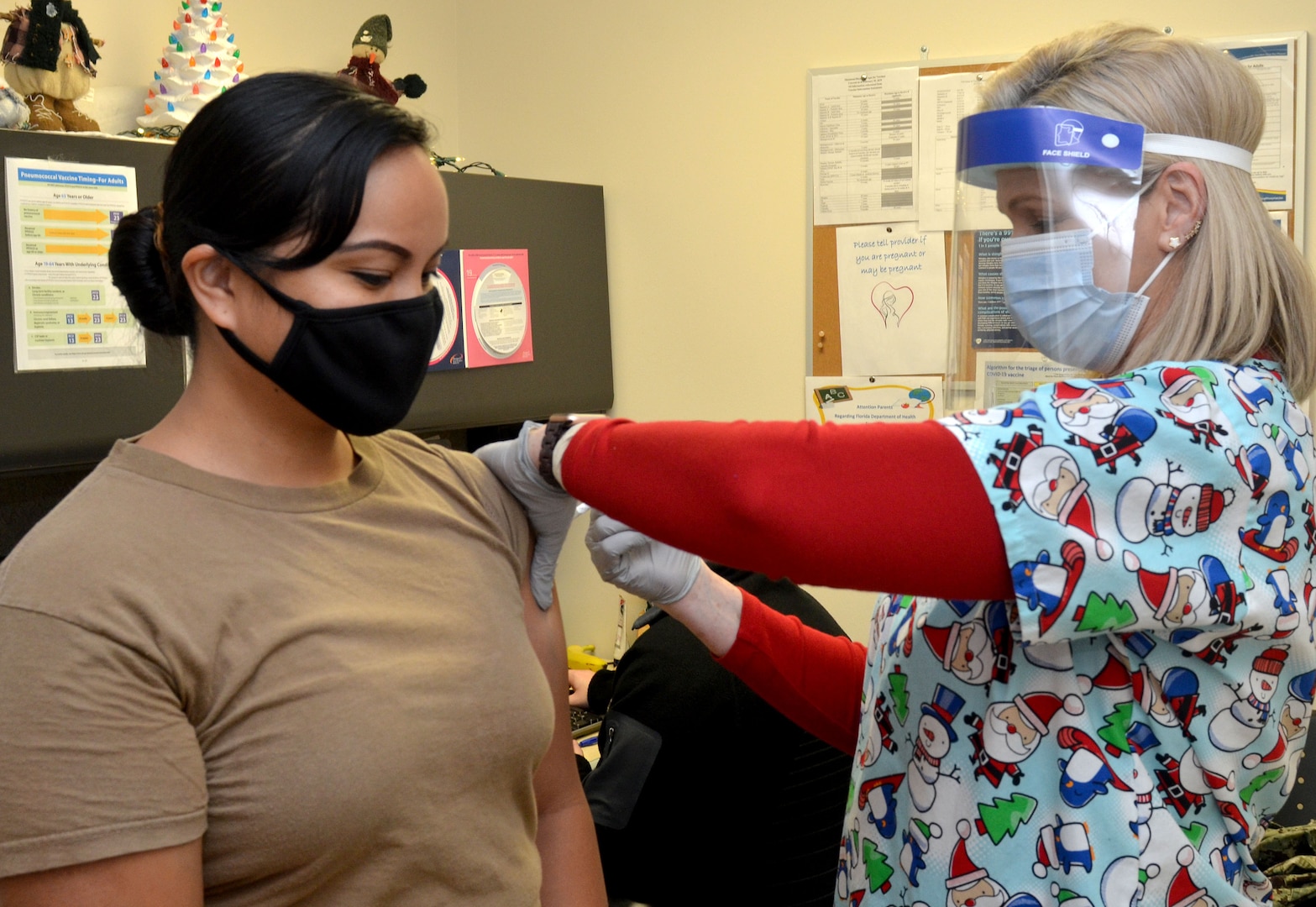 Hospital Corpsman 2nd Class Grace Layugan receives a COVID-19 vaccine at Naval Hospital Jacksonville.