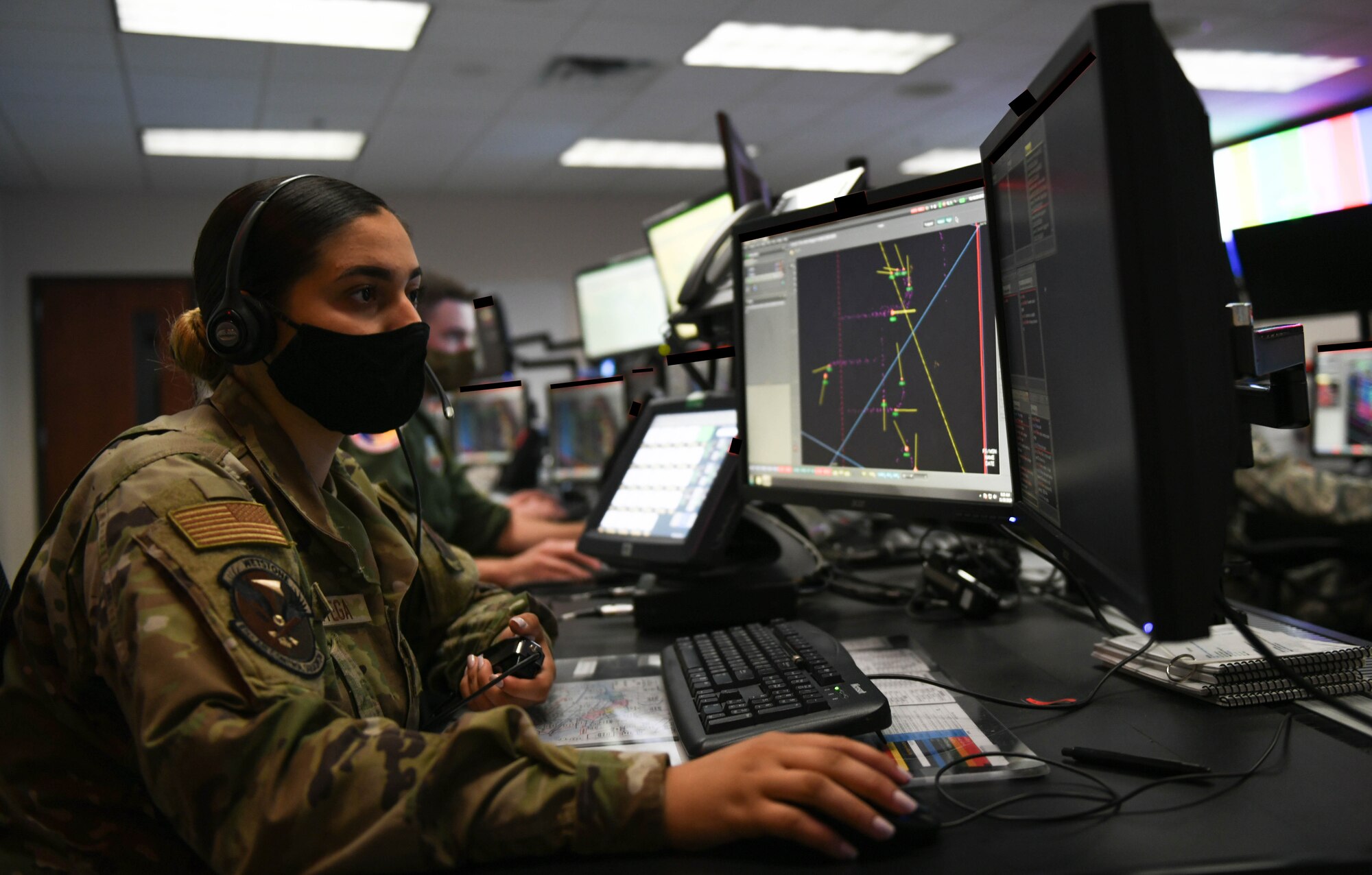 woman monitors radar screen