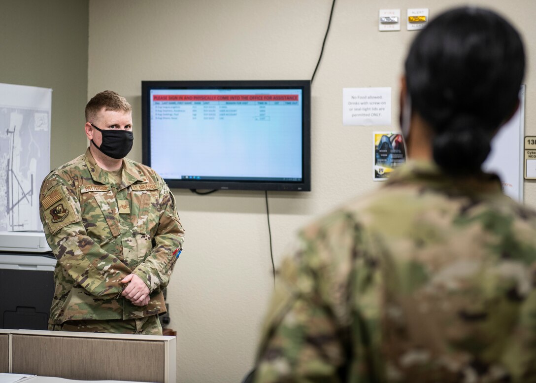 Photo of two Airmen standing across from each other