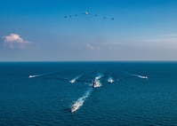 The Royal Saudi Naval Force corvette HMS Badr (612), front to back, the guided-missile destroyer USS Winston S. Churchill (DDG 81), Navy patrol coastal ships USS Squall (PC 7), USS Firebolt (PC 10), Coast Guard patrol boats USCGC Monomoy (WPB 1326), USCGC Maui (WPB 1304) and USCGC Wrangell (WPB 1332) transit the Arabian Gulf with Royal Saudi Air Force F-15SA fighter jets, U.S. Air Force F-16 Fighting Falcon fighter jets, a U.S. Navy MH-60R Sea Hawk helicopter and a U.S. Navy P-8A Poseidon aircraft during the joint and combined air operations in support of maritime surface warfare (AOMSW) exercise in the Arabian Gulf, Dec. 17. Combined integration operations between joint U.S. forces are regularly held to maintain interoperability and the capability to counter threats posed in the maritime domain, ensuring freedom of navigation and free flow of commerce throughout the region's heavily trafficked waterways.