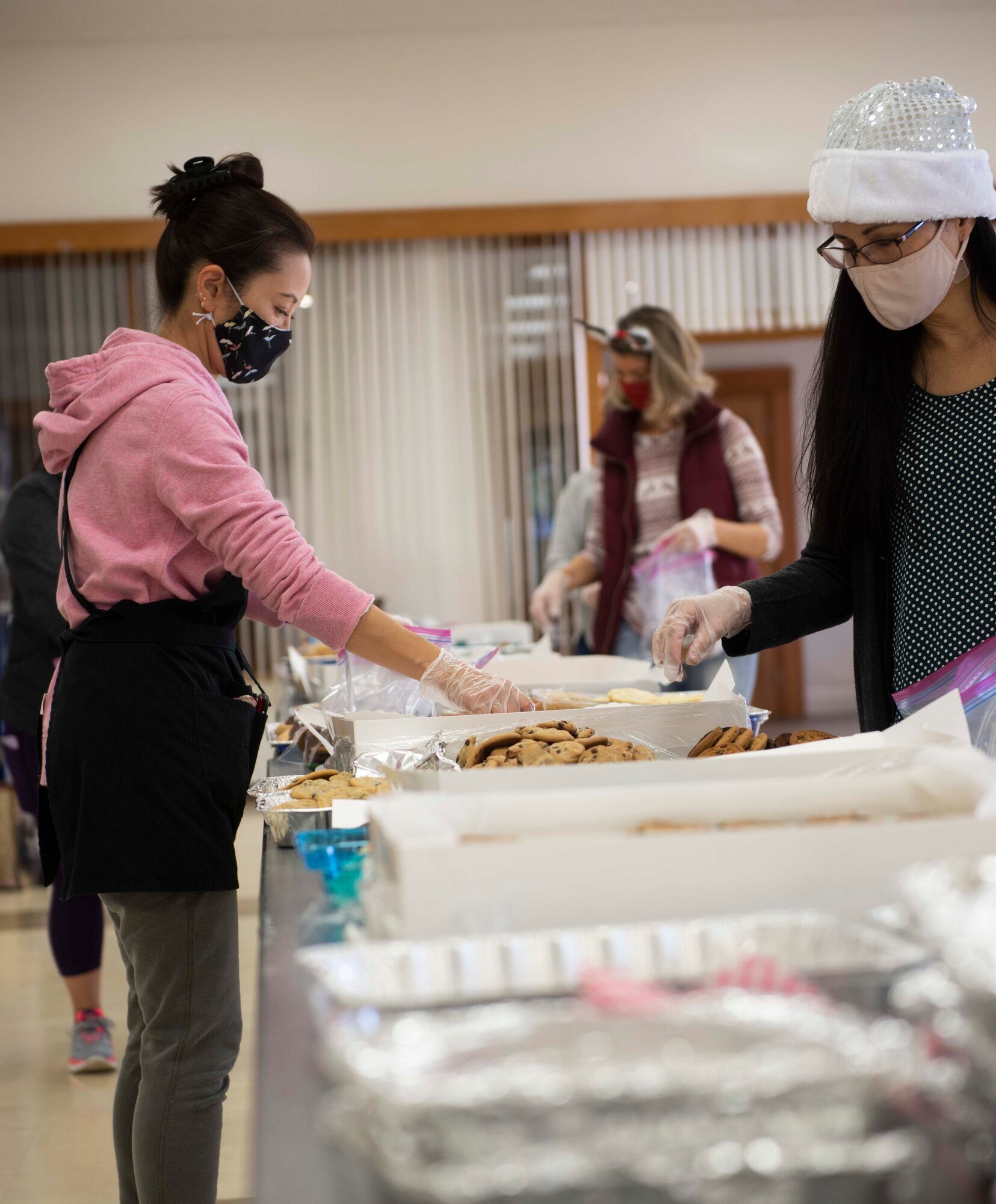 A volunteer grabs a home-baked treat during the 2020 Team Yokota Cookie Crunch at the Friendship Chapel on Yokota Air Base, Japan, Dec. 18, 2020. This year’s goal for the Cookie Crunch was for volunteer bakers to provide 15,600 cookies to Airmen across the base. (U.S. Air Force photo by Airman 1st Class Hannah Bean)