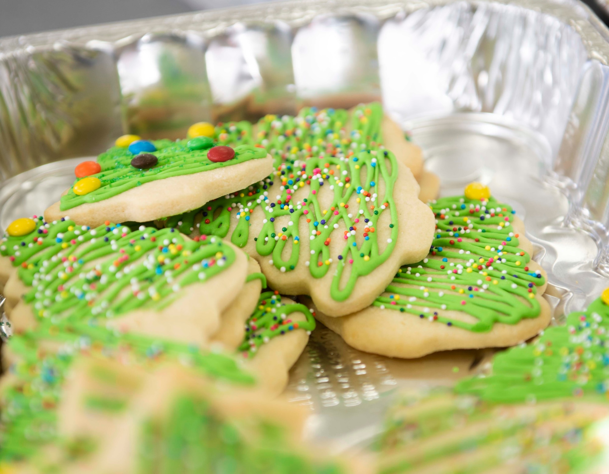 Decorated Christmas cookies lie in a tin for the 2020 Team Yokota Cookie Crunch on Yokota Air Base, Japan, Dec. 18, 2020. The intention behind Cookie Crunch is to provide unaccompanied U.S. and Japan Air Self-Defense Force Airmen living in the dormitories one-dozen cookies each during the holiday season. (U.S. Air Force photo by Airman 1st Class Hannah Bean)