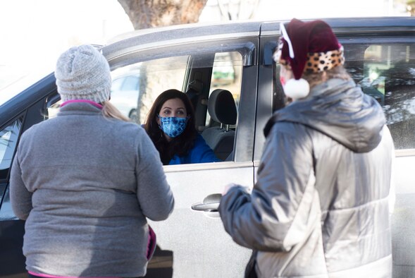 A volunteer baker drops off cookies for the 2020 Team Yokota Cookie Crunch on Yokota Air Base, Japan, Dec. 18, 2020. More than 15,600 cookies were donated, bagged and distributed to single U.S. and Japan Air Self-Defense Force Airmen. (U.S. Air Force photo by Airman 1st Class Hannah Bean)