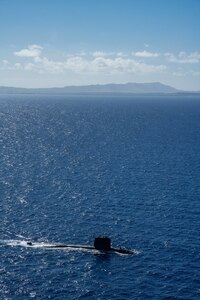 WATERS OFF GUAM (Dec. 11, 2020) The French Navy Rubis-class nuclear powered submarine (SSN) Émeraude steams off the coast of Guam during a photo exercise with the Los Angeles-class fast-attack submarine USS Asheville (SSN 758). Asheville and Émeraude practiced high-end maritime skills in a multitude of disciplines designed to enhance interoperability between maritime forces. Asheville is one of four forward-deployed submarines assigned to Commander, Submarine Squadron 15. (U.S. Navy photo by Mass Communication Specialist 2nd Class Kelsey J. Hockenberger)