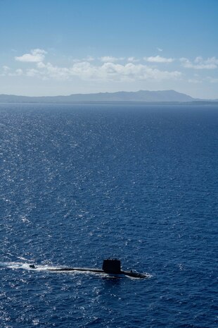 WATERS OFF GUAM (Dec. 11, 2020) The French Navy Rubis-class nuclear powered submarine (SSN) Émeraude steams off the coast of Guam during a photo exercise with the Los Angeles-class fast-attack submarine USS Asheville (SSN 758). Asheville and Émeraude practiced high-end maritime skills in a multitude of disciplines designed to enhance interoperability between maritime forces. Asheville is one of four forward-deployed submarines assigned to Commander, Submarine Squadron 15. (U.S. Navy photo by Mass Communication Specialist 2nd Class Kelsey J. Hockenberger)