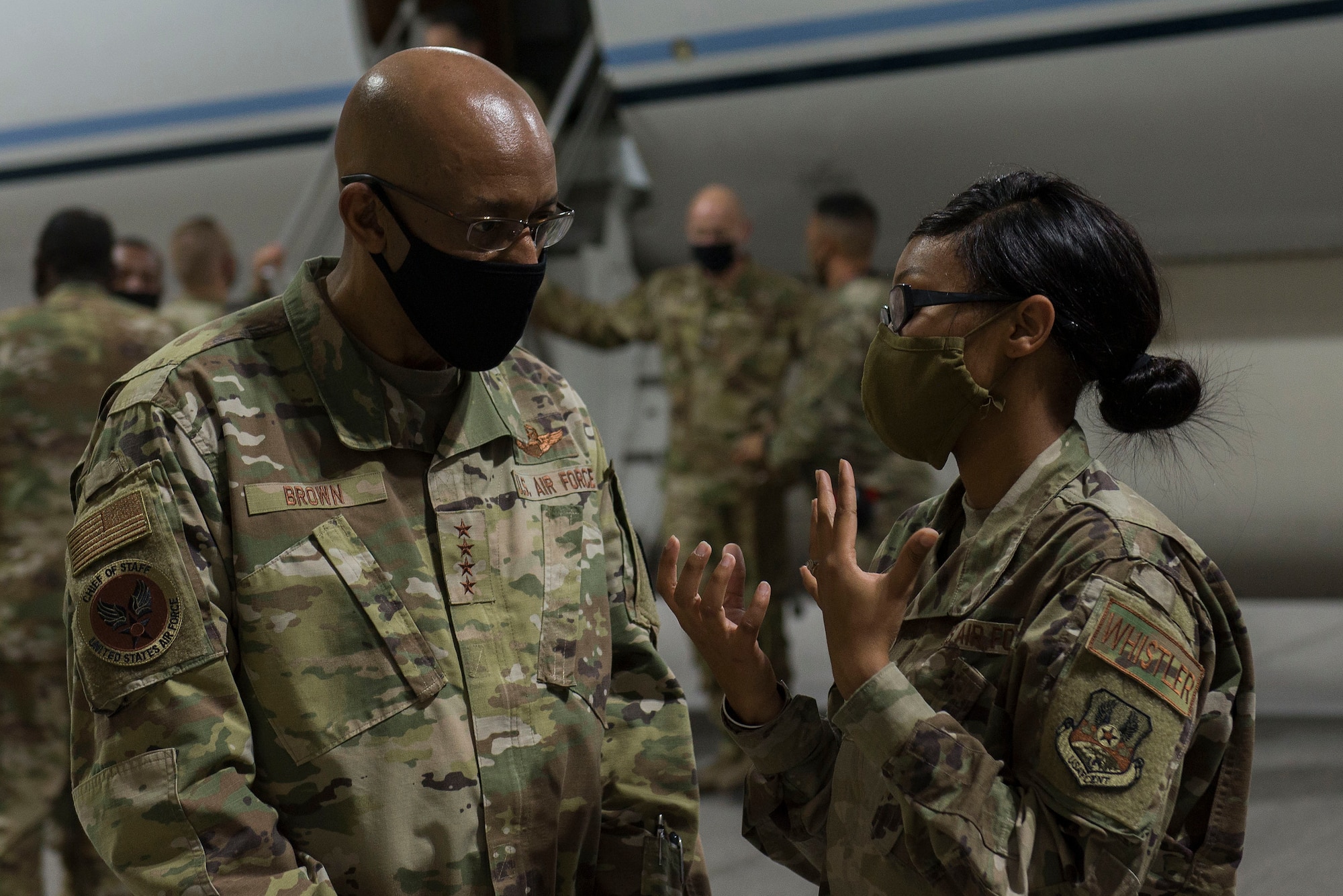 Chief of Staff of the Air Force Gen. Charles Q. Brown, Jr. speaks with an Airman assigned to the 380th Air Expeditionary Wing (AEW) during a visit to Al Dhafra Air Base, United Arab Emirates, Dec. 21, 2020.