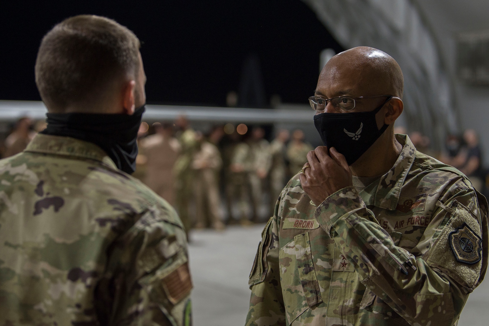 Chief of Staff of the Air Force Gen. Charles Q. Brown, Jr. speaks with an Airman assigned to the 380th Air Expeditionary Wing during a visit to Al Dhafra Air Base, United Arab Emirates, Dec. 21, 2020.