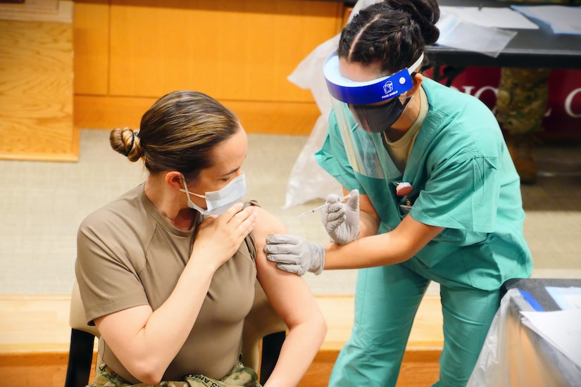 A service member gets a vaccine.