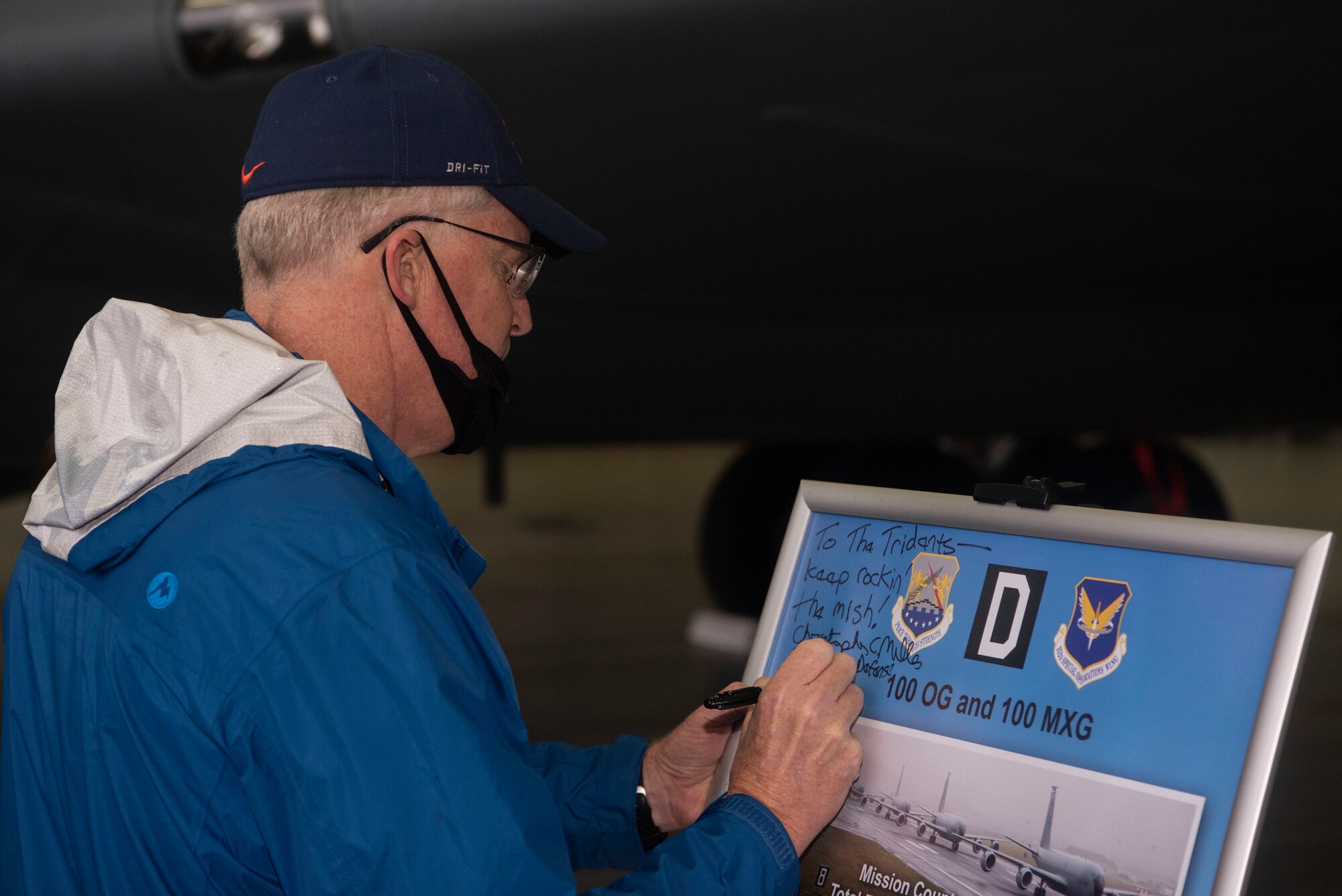 U.S. Acting Secretary of Defense Christopher Miller writes a message to the 100th Air Refueling Wing at Royal Air Force Mildenhall, England, Dec. 21, 2020. Miller visited the base to present the 2020 Secretary of Defense Maintenance Effectiveness Award to the 100th Maintenance Group. (U.S. Air Force photo by Airman 1st Class Joseph Barron)