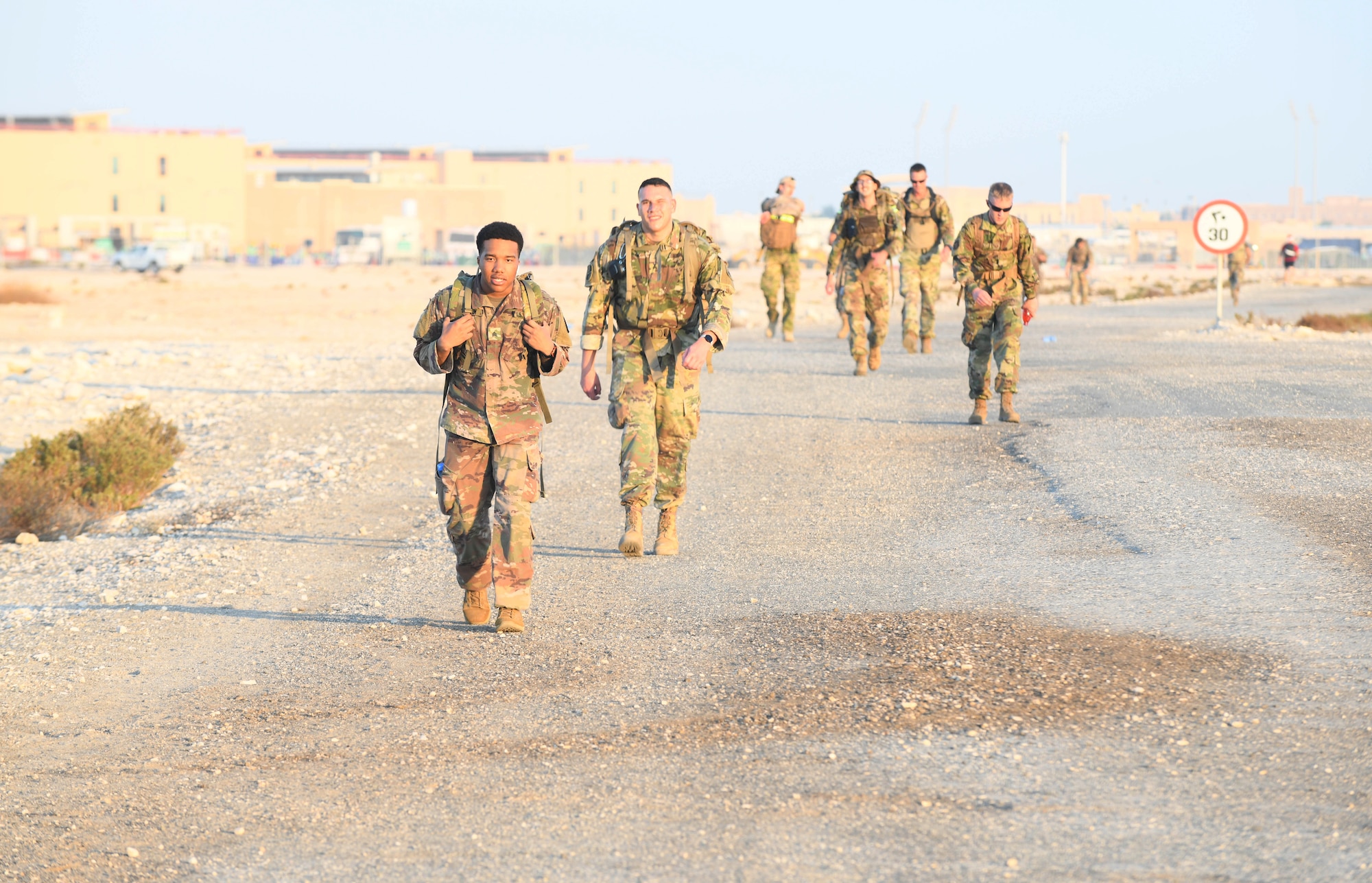U.S. and coalition military members ruck together during the traditional 30-kilometer (18.6-mile) Norwegian foot march event. The tradition began in 1915, 10 years after Norway gained its independence from Sweden and has become a rite of passage for all Norwegian military members. They joined nearly 120 other coalition members, including Americans, Australians, New Zealanders, British and Canadians who participated in the march under the supervision of Norwegian armed forces Capt. Magne Rambo, deployed to Al Udeid AB as part of the U.S. Central Command Partner Integration Enterprise. (U.S. Air Force photo by Staff Sgt. Kayla White)