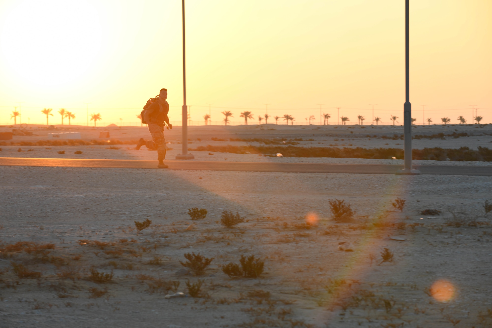 U.S. Army Private 1st Class Isaac Vieau, an ammunition supply specialist, 395th Ordnance Company, deployed to Al Udeid Air Base, Qatar, rucks through sunrise Dec. 5, 2020, while participating in the traditional 30-kilometer (18.6-mile) Norwegian foot march event. The tradition began in 1915, 10 years after Norway gained its independence from Sweden and has become a rite of passage for all Norwegian military members. Vieau was one of nearly 120 coalition members, including Americans, Australians, New Zealanders, British and Canadians who participated in the march under the supervision of Norwegian armed forces Capt. Magne Rambo, deployed to Al Udeid AB as part of the U.S. Central Command Partner Integration Enterprise. (U.S. Air Force photo by Staff Sgt. Kayla White)