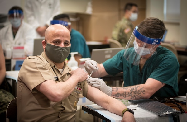 Master Chief Petty Officer of the Navy (MCPON) Russell Smith receives the COVID-19 vaccine.