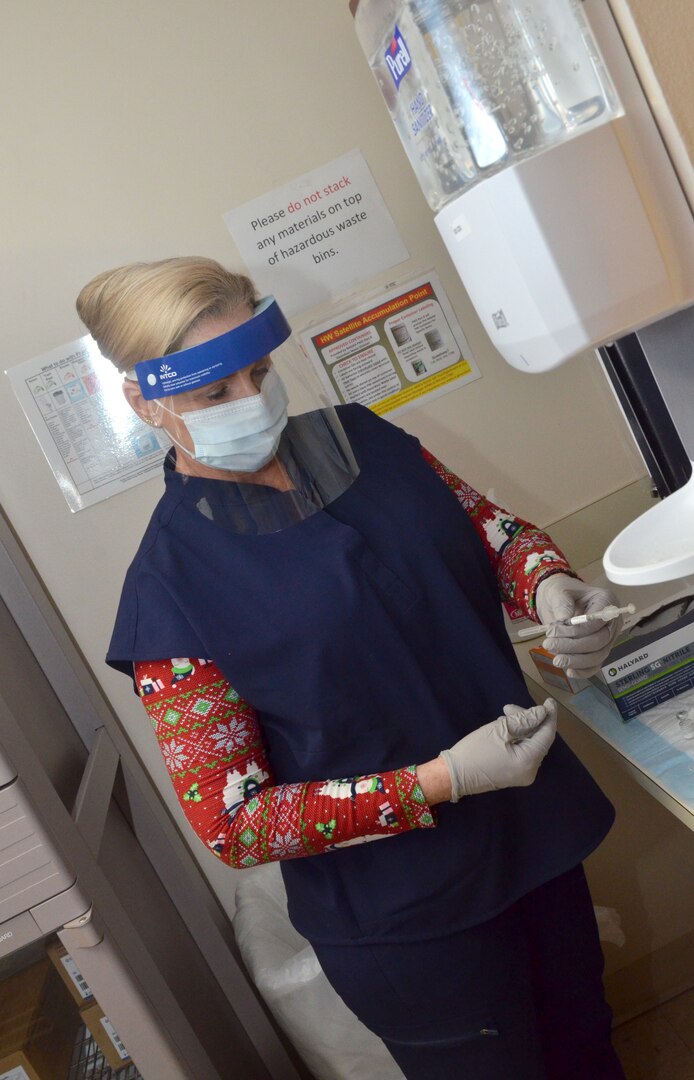 Amy Doughty, a licensed practical nurse at Naval Hospital Jacksonville’s Immunizations Clinic, prepares COVID-19 vaccine to be administered to healthcare personnel on Dec. 16.