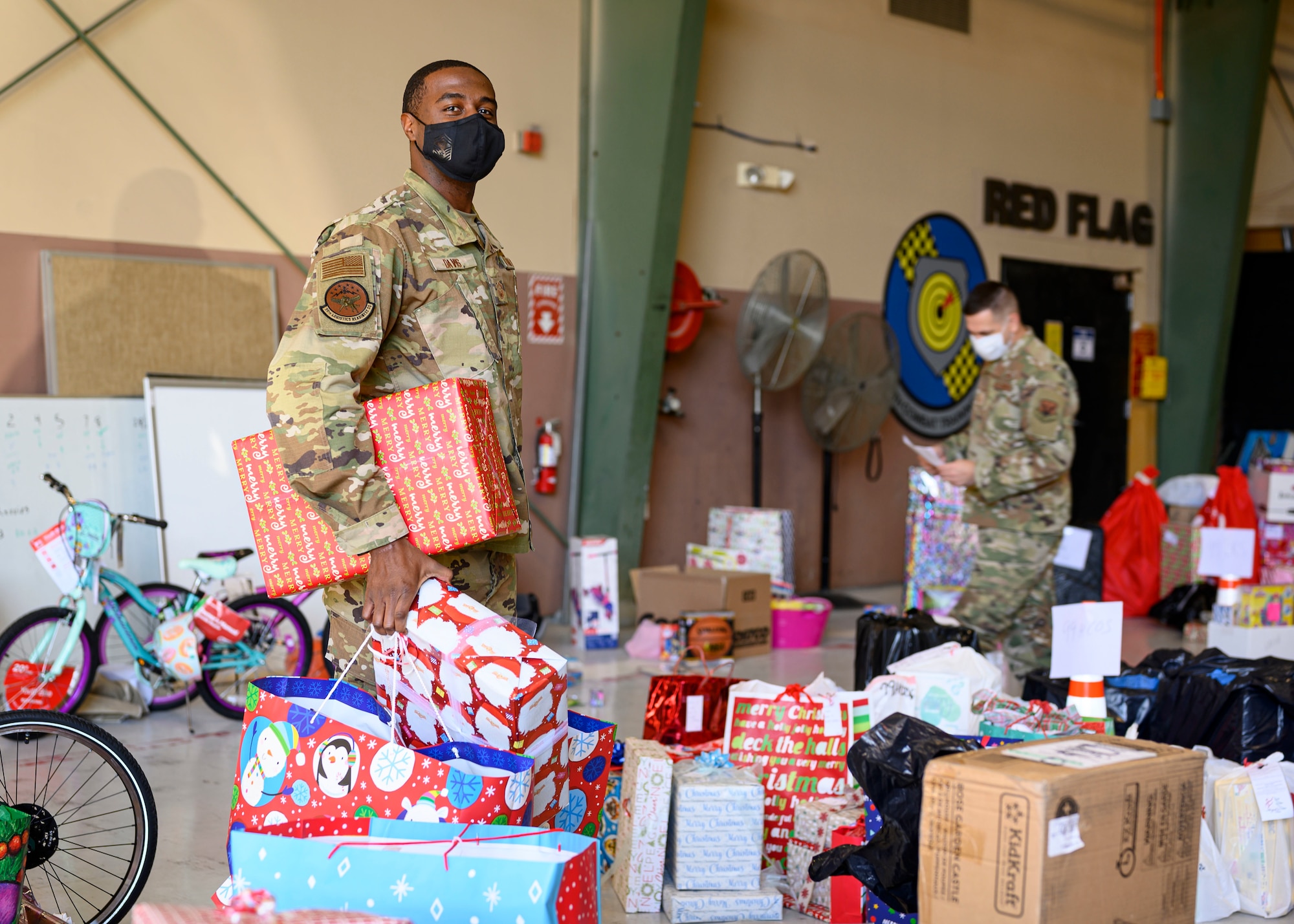 airmen sort through wrapped gifts