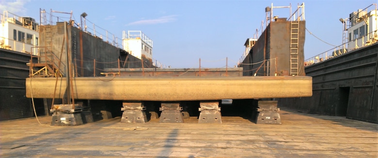 IN THE PHOTO, an old photo of one of the smaller dry docks called the 1015 lifted for maintenance onto the 5801 dry dock. The 1015 is older and was built around 1930.