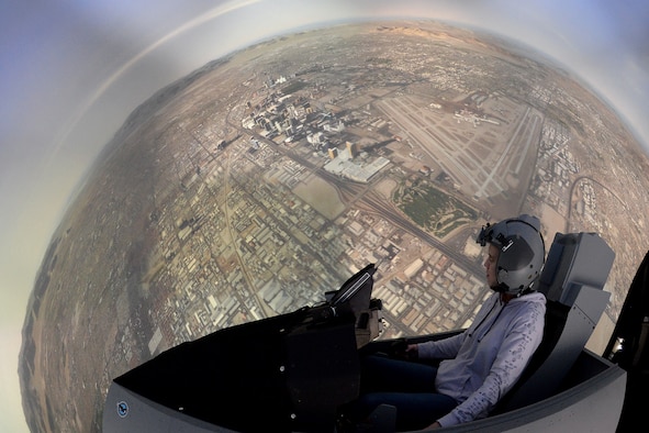 Alyssa Heaton, a computer scientist in the 309th Software Engineering Group, checks out software upgrades as she “flies” in an F-16 simulator over Las Vegas, Nevada. The 309th Software Engineering Group has a positive and direct impact across multiple essential platforms such as the A-10, F-16, F-22, F-35, Ground Based Strategic Deterrent, Space Systems, and Command and Control.  (U.S. Air Force photo by Alex R. Lloyd)