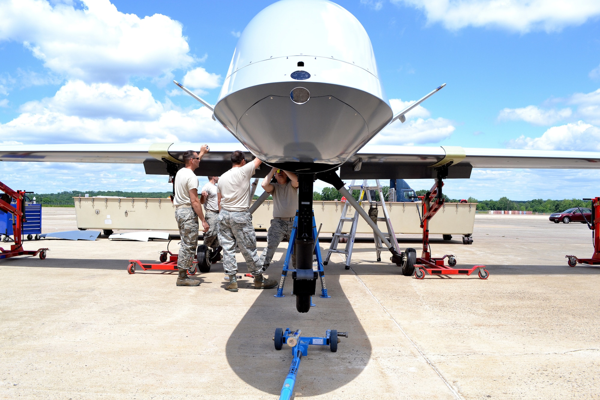 An aircraft maintenance team from the 174th Attack Wing out of Syracuse, N.Y., assemble a static display General Atomics MQ-9 Reaper on June 6, 2014 at Horsham Air Guard Station.