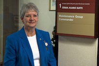 Erma Asaro, an administrative executive assistant for the 437th Maintenance Group, poses with her suite dedication plaque during her retirement ceremony, at Joint Base Charleston S.C., Dec. 18, 2020. Asaro served 51 years of outstanding service and was instrumental in the success of numerous large formation exercises, humanitarian relief operations and real world contingencies.