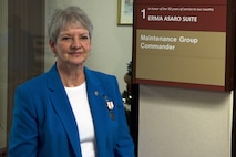 Erma Asaro, an administrative executive assistant for the 437th Maintenance Group, poses with her suite dedication plaque during her retirement ceremony, at Joint Base Charleston S.C., Dec. 18, 2020. Asaro served 51 years of outstanding service and was instrumental in the success of numerous large formation exercises, humanitarian relief operations and real world contingencies.
