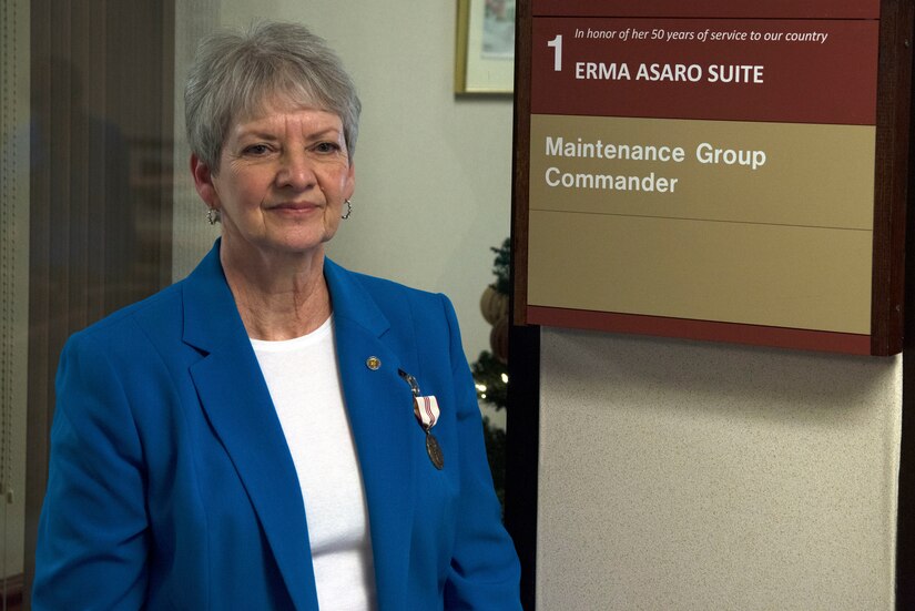 Erma Asaro, an administrative executive assistant for the 437th Maintenance Group, poses with her suite dedication plaque during her retirement ceremony, at Joint Base Charleston S.C., Dec. 18, 2020. Asaro served 51 years of outstanding service and was instrumental in the success of numerous large formation exercises, humanitarian relief operations and real world contingencies.