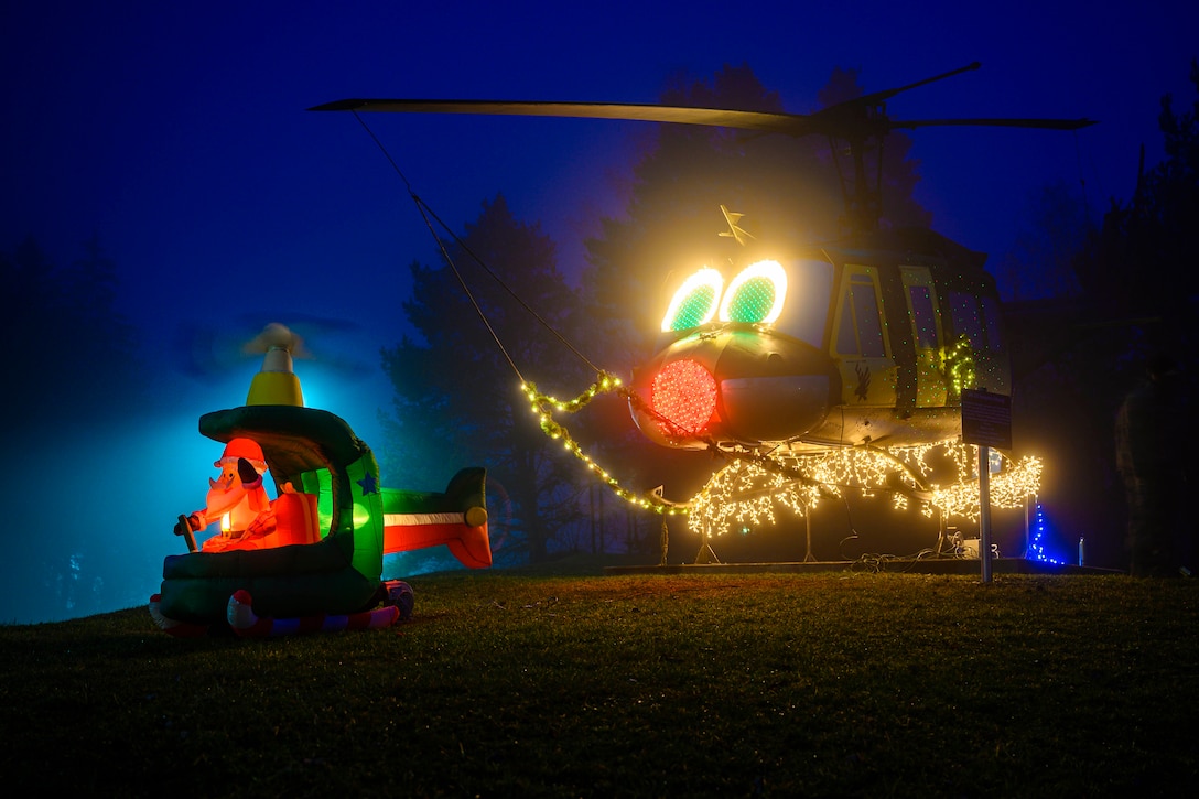 A helicopter is decorated with holiday lights.