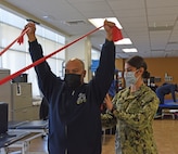 Lt. Erin Kocher assists a Chief Petty Officer with shoulder-strengthening exercises in the Physical Therapy Department of the Adult Medical Care Facility, a branch clinic of Naval Hospital Twentynine Palms.