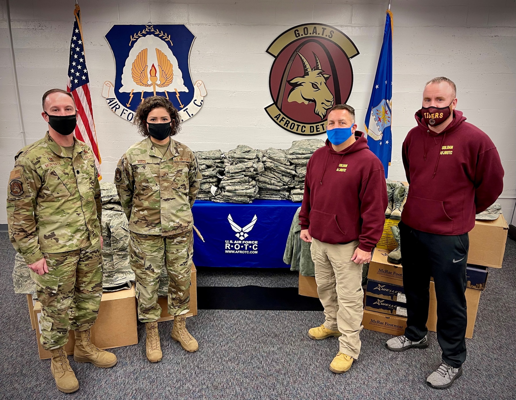 Leadership from Air Force ROTC Detachment 207 donate a supply of Airman Battle Uniform sets to the Air Force Junior ROTC detachment at Soldan International Studies High School at Saint Louis University, St. Louis, Missouri Dec. 18, 2020. The uniforms -- which include blouses, pants, boots, hats, all-weather coats, and accessories -- will be used to outfit some of the more than 150 high school students in the AFJROTC detachment.