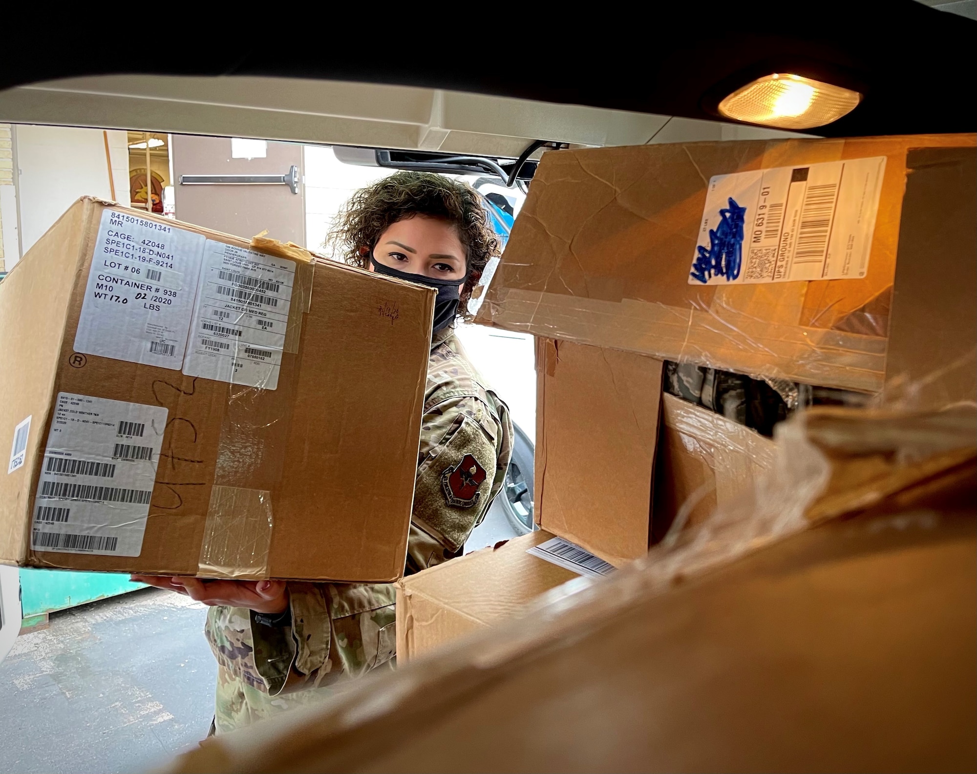 U.S. Air Force Master Sgt. Coralys Ross, noncommissioned officer in charge of Air Force ROTC Detachment 207, loads boxes filled with Airman Battle Uniform items into a car during a donation event at Saint Louis University, St. Louis, Missouri Dec. 18, 2020. The donation to a local Air Force Junior ROTC detachment, valued at more than $20,000, resulted from the transition of Air Force ROTC cadets to the Operational Camouflage Pattern uniform during the Fall 2020 academic semester.
