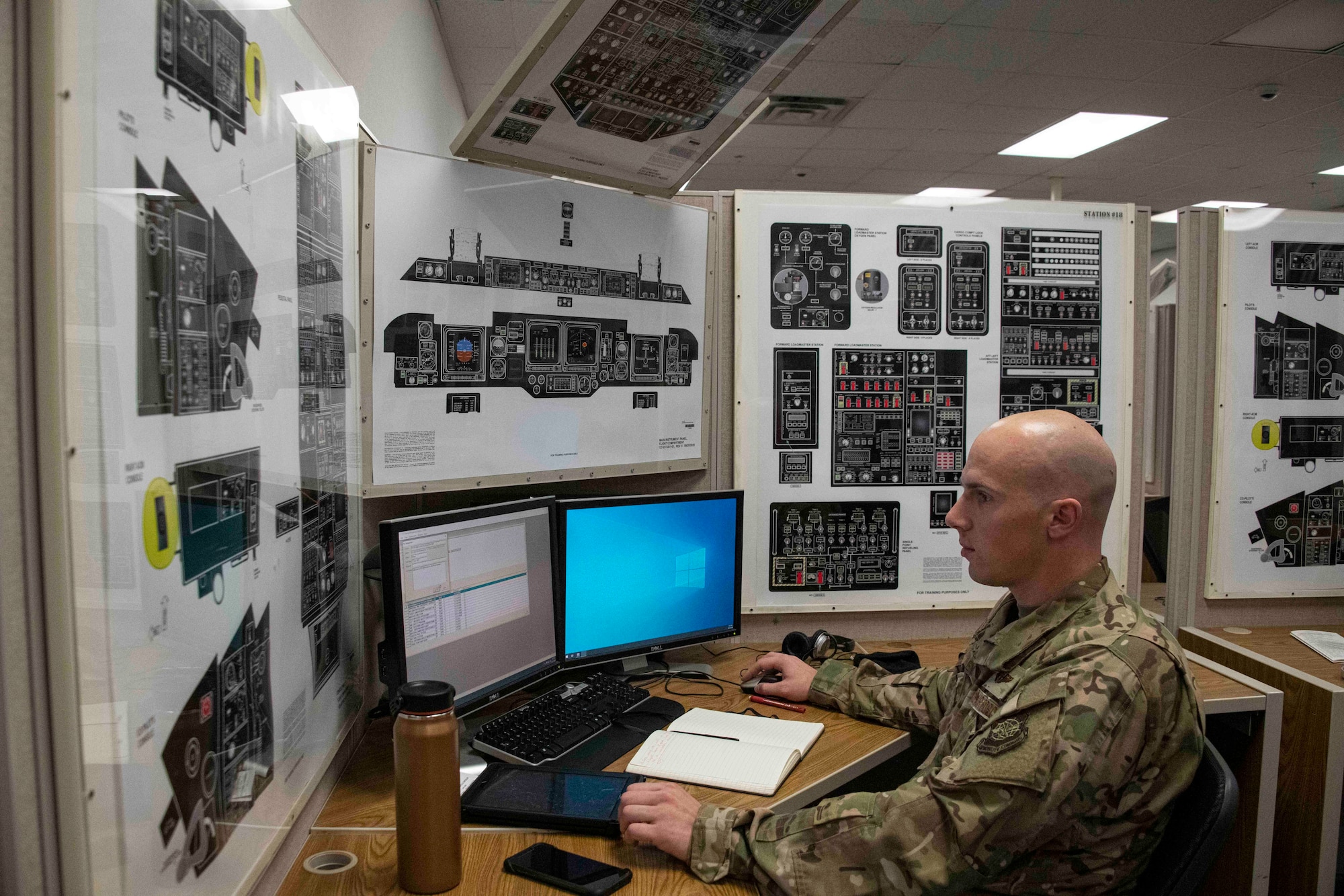 man sits a computer desk