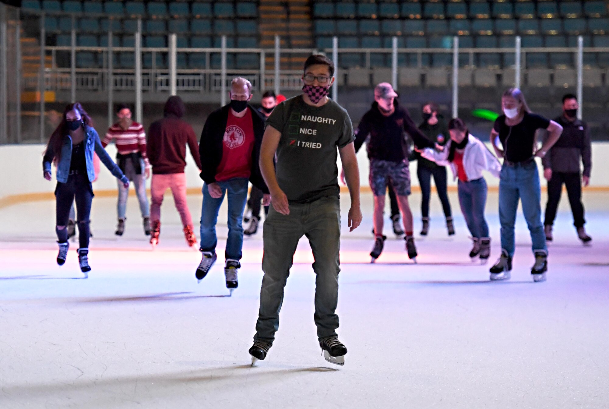 Airmen from the 81st Training Group ice skate inside the Mississippi Coast Coliseum in Biloxi, Mississippi, Dec. 18, 2020. The 81st TRG held various events for Airmen at Keesler Air Force Base, Mississippi, to participate in throughout the holidays, to include ice skating, inflatables, a scavenger hunt and a bubble ball soccer tournament. (U.S. Air Force photo by Kemberly Groue)