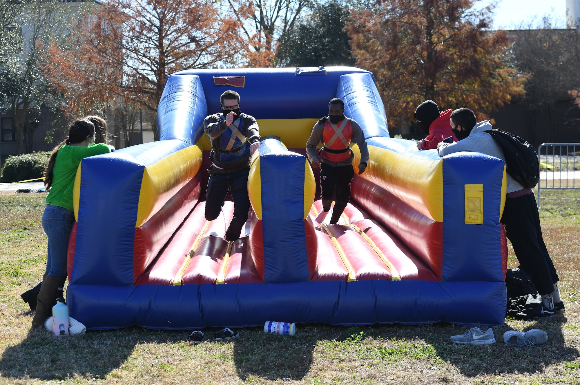 U.S. Air Force Airman 1st Class Tavis Pascual and Airman Joseph Delijah, 336th Training Squadron, participate in an inflatable race at Keesler Air Force Base, Mississippi, Dec. 18, 2020. The 81st Training Group held various events for Airmen to participate in throughout the holidays, to include ice skating, inflatables, a scavenger hunt and a bubble ball soccer tournament. (U.S. Air Force photo by Kemberly Groue)