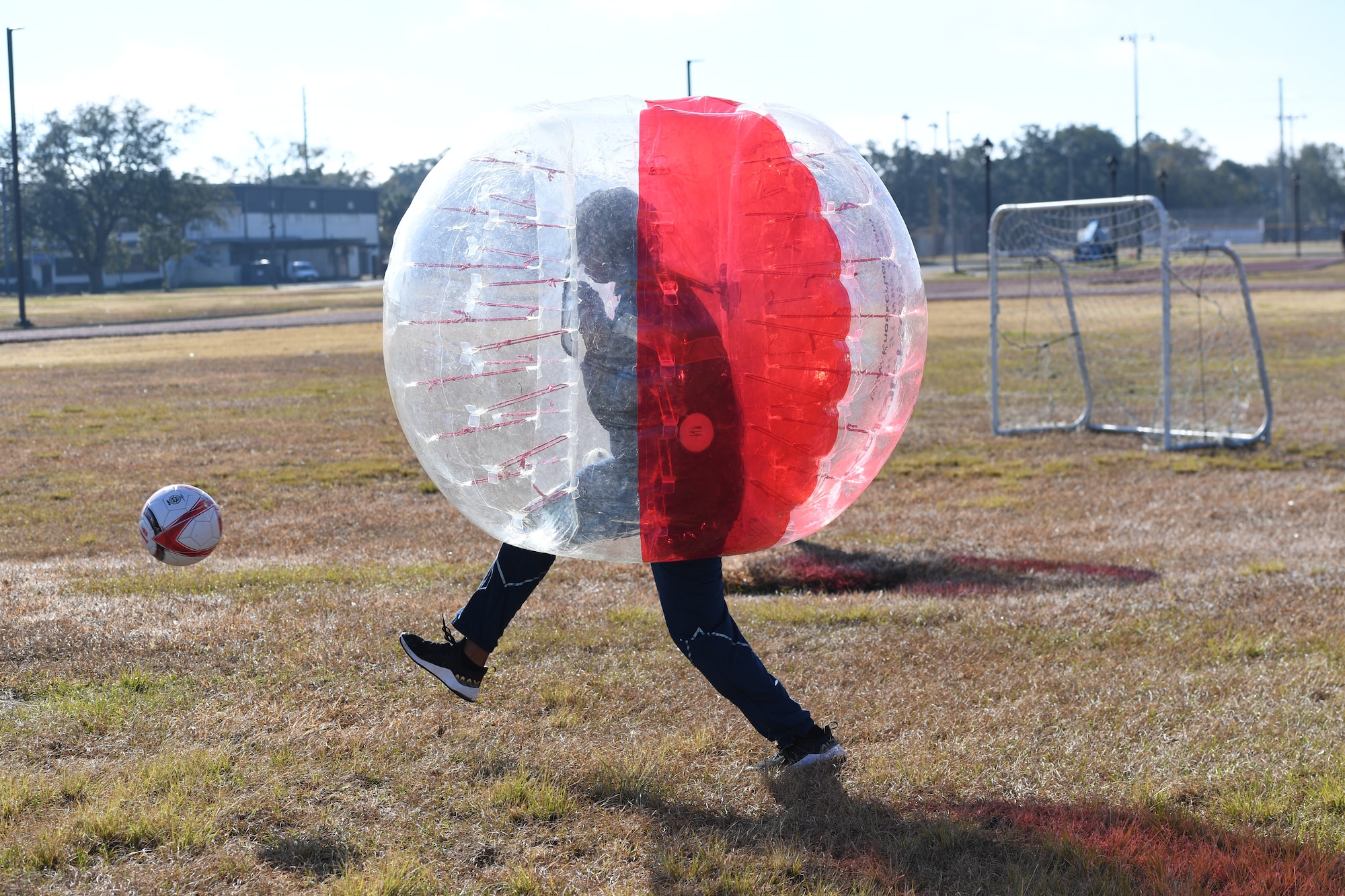 An Airman from the 81st Training Group participates in a bubble ball soccer tournament at Keesler Air Force Base, Mississippi, Dec. 21, 2020. The 81st TRG held various events for Airmen to participate in throughout the holidays, to include ice skating, inflatables, a scavenger hunt and a bubble ball soccer tournament. (U.S. Air Force photo by Kemberly Groue)