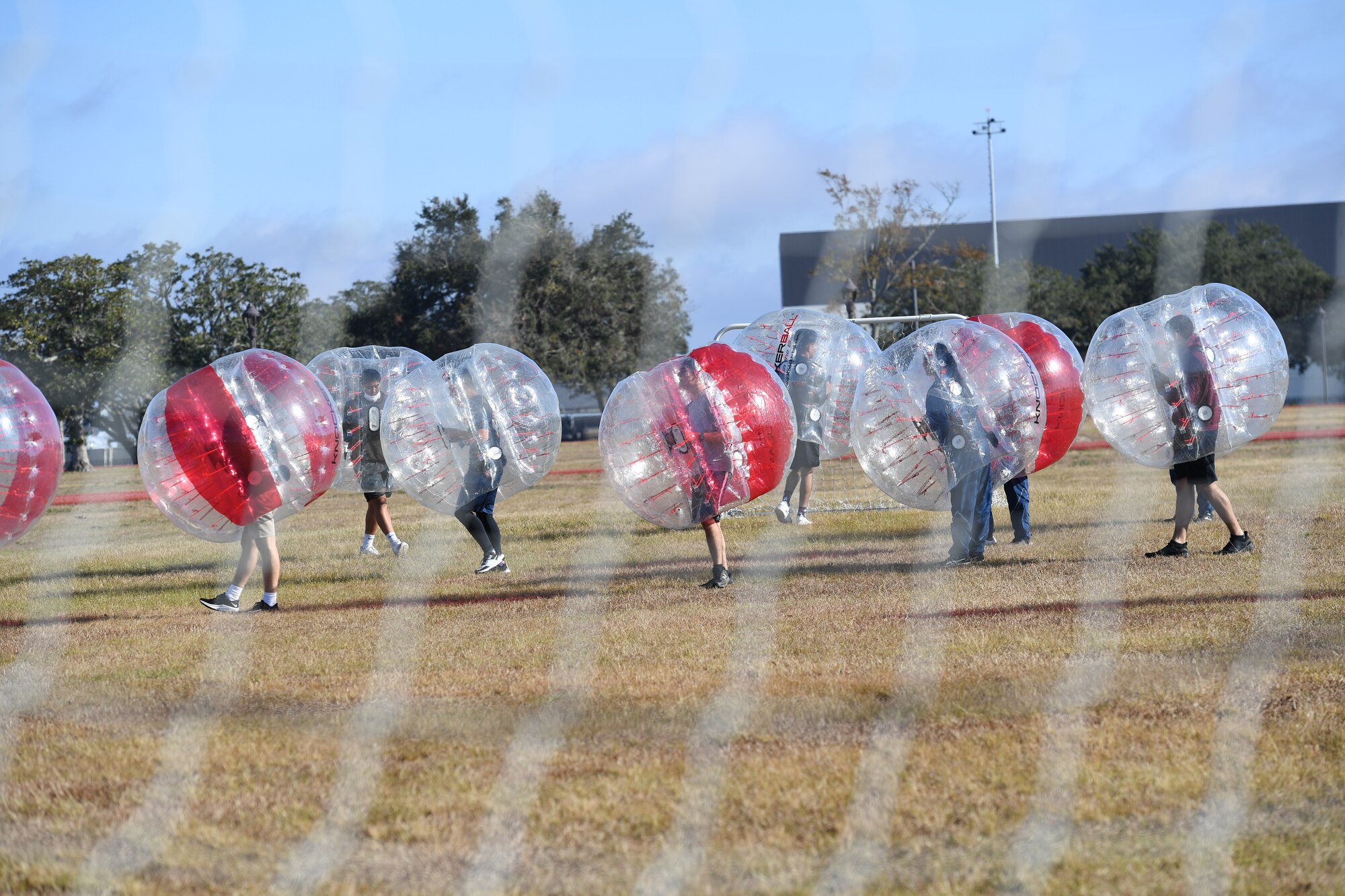 Airmen from the 81st Training Group participate in a bubble ball soccer tournament at Keesler Air Force Base, Mississippi, Dec. 21, 2020. The 81st TRG held various events for Airmen to participate in throughout the holidays, to include ice skating, inflatables, a scavenger hunt and a bubble ball soccer tournament. (U.S. Air Force photo by Kemberly Groue)