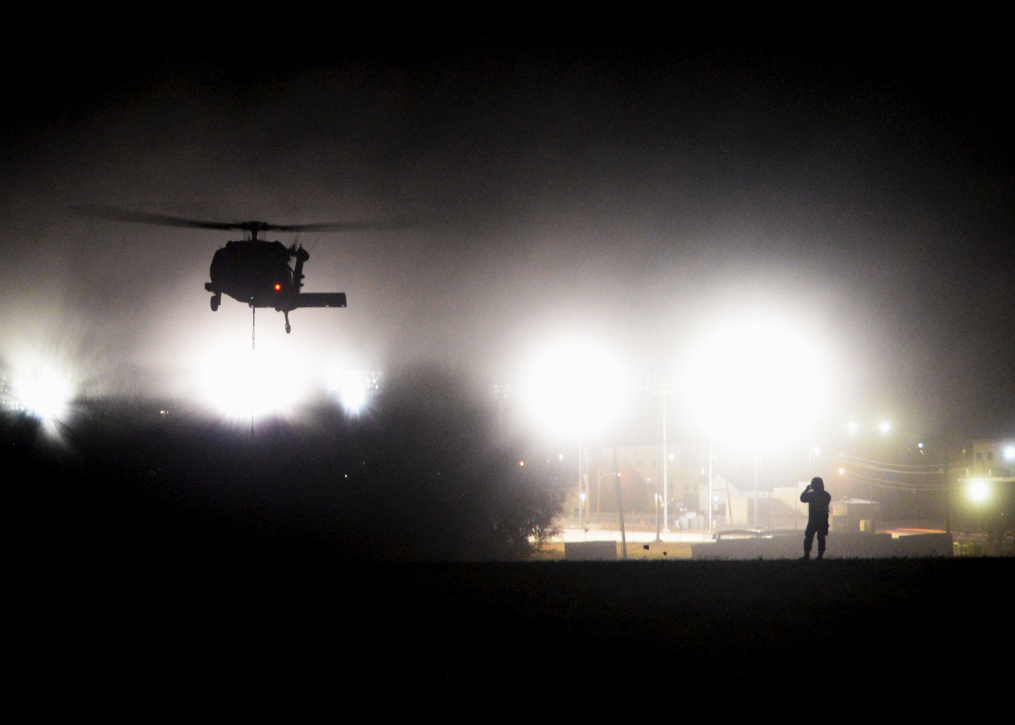 A UH-60 Black Hawk helicopter lowers sling loaded cargo onto the ground during Operation Nightstorm Dec. 15, 2020, at Joint Base San Antonio-Chapman Training Annex, Texas. (U.S. Air Force photo by Tech. Sgt. Samantha Mathison)