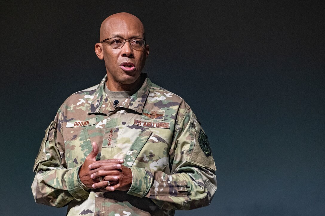 A man in a military uniform appears on a stage.