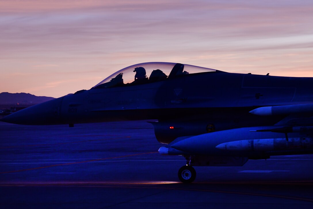 Lt. Col. Stephen Graham, 84th TES electronic warfare test director, taxis on the flight line as he prepares to conduct Force Development Evaluations of multiple systems on the F-16, Dec. 15, Nellis Air Force Base, Nev. (U.S. Air Force Photo by Major Mike Giaquinto)