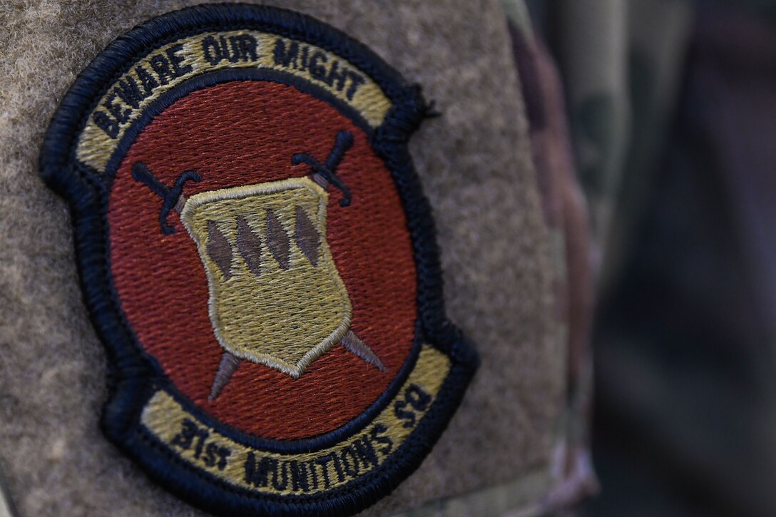 Senior Airman Jaelen Chaney, 31st Munitions Squadron armament technicians, wears a 31st MUNS patch at Aviano Air Base, Italy, Dec. 21, 2020. The 31st MUNS maintains equipment and a combat ready stockpile to support U.S. and NATO taskings. Airmen from the 31st MUNS armament flight ensure they remain mission ready throughout the COVID-19 pandemic. (U.S. Air Force photo by Airman 1st Class Ericka A. Woolever)