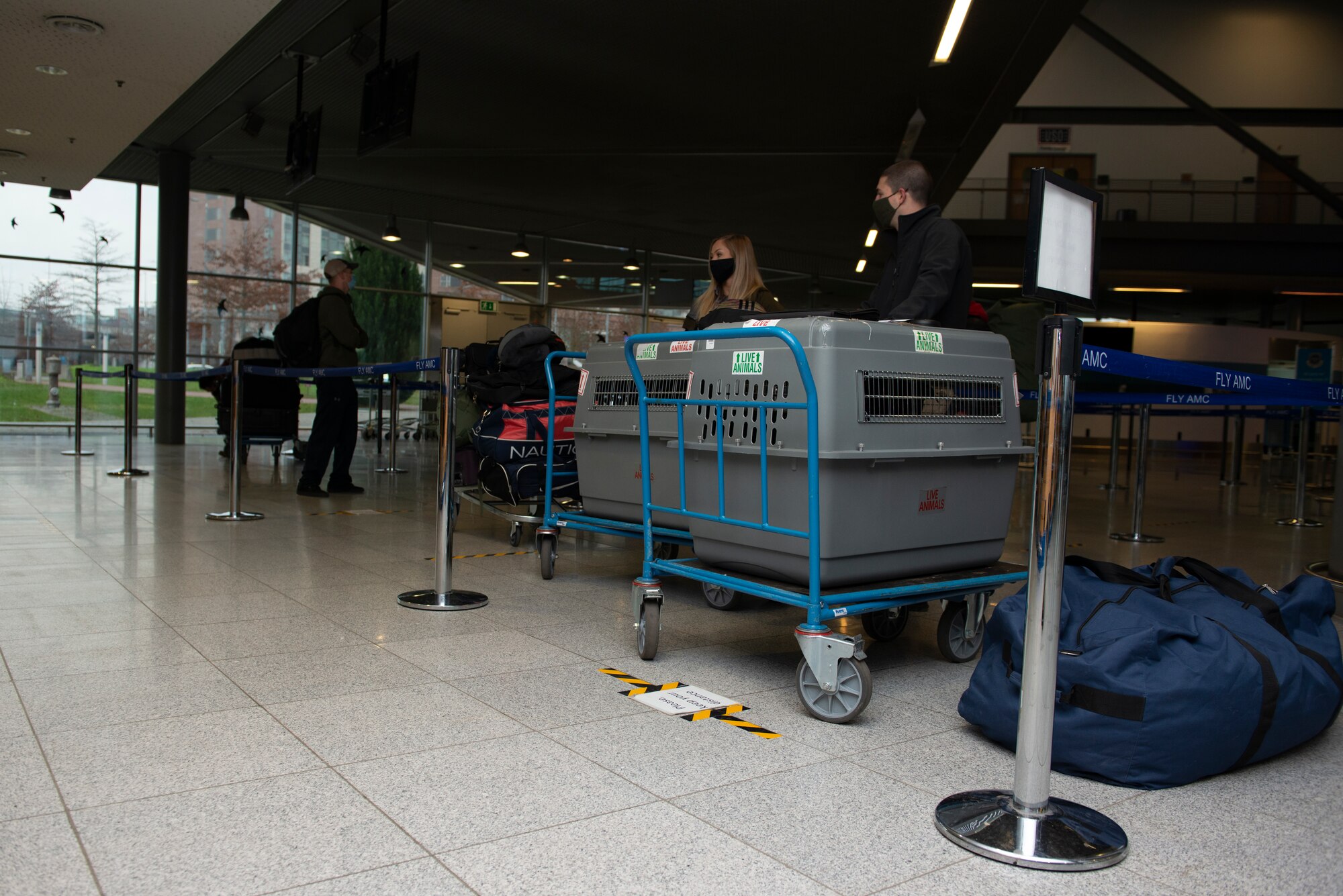 Passenger terminal patrons wait in line.