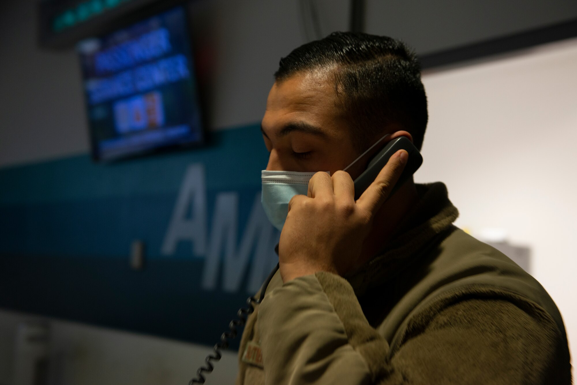 A photo of an Airman taking a call.