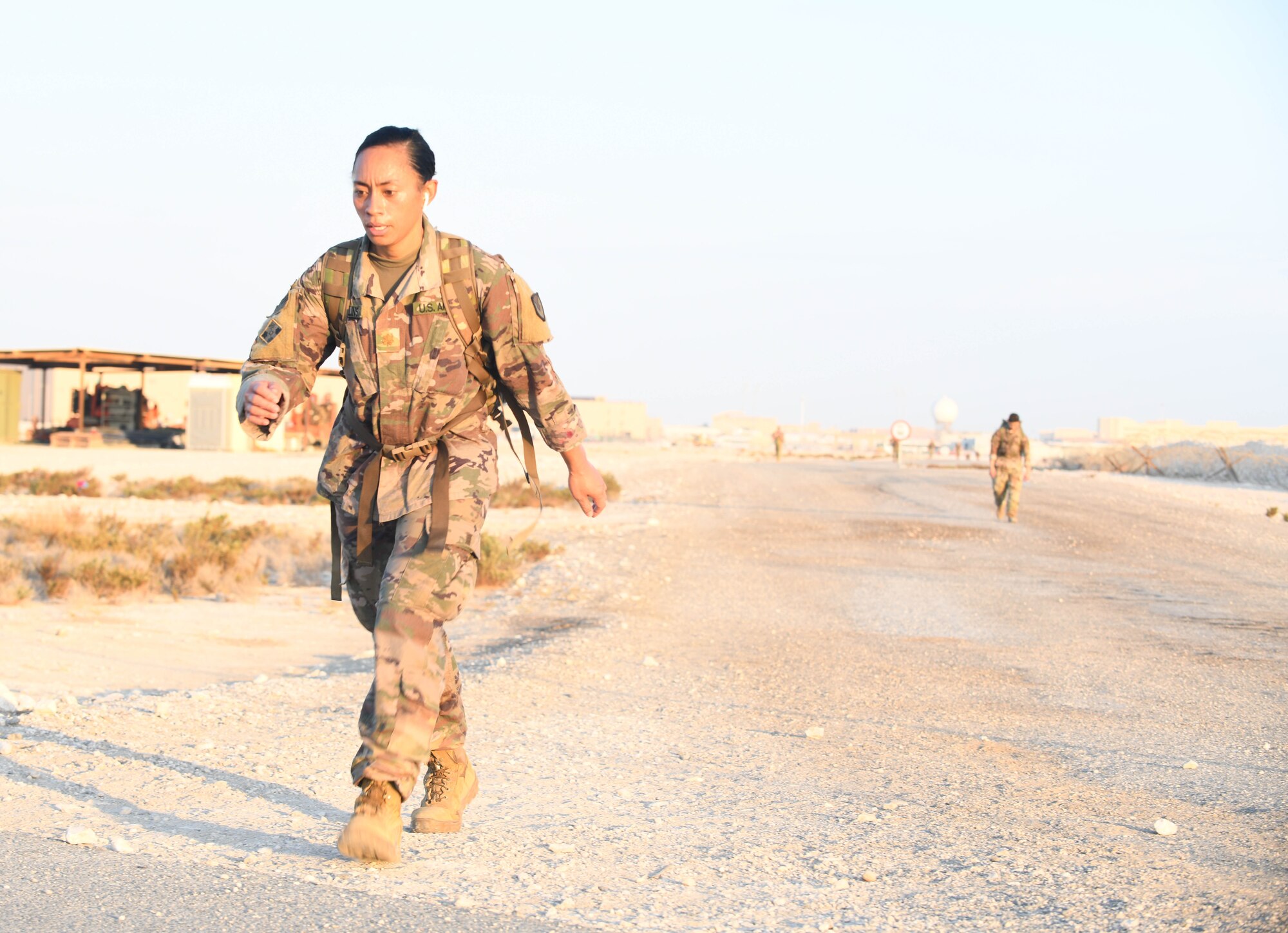 U.S. Army Maj. Lilieni Collins, deployed to Al Udeid Air Base, Qatar, as part of the Army Contracting Command-Afghanistan's team, hustles through the traditional 30-kilometer (18.6-mile) Norwegian foot march event. The tradition began in 1915, 10 years after Norway gained its independence from Sweden and has become a rite of passage for all Norwegian military members. Collins joined nearly 120 other coalition members, including Americans, Australians, New Zealanders, British and Canadians who participated in the march under the supervision of Norwegian armed forces Capt. Magne Rambo, deployed to Al Udeid AB as part of the U.S. Central Command Partner Integration Enterprise. (U.S. Air Force photo by Staff Sgt. Kayla White)