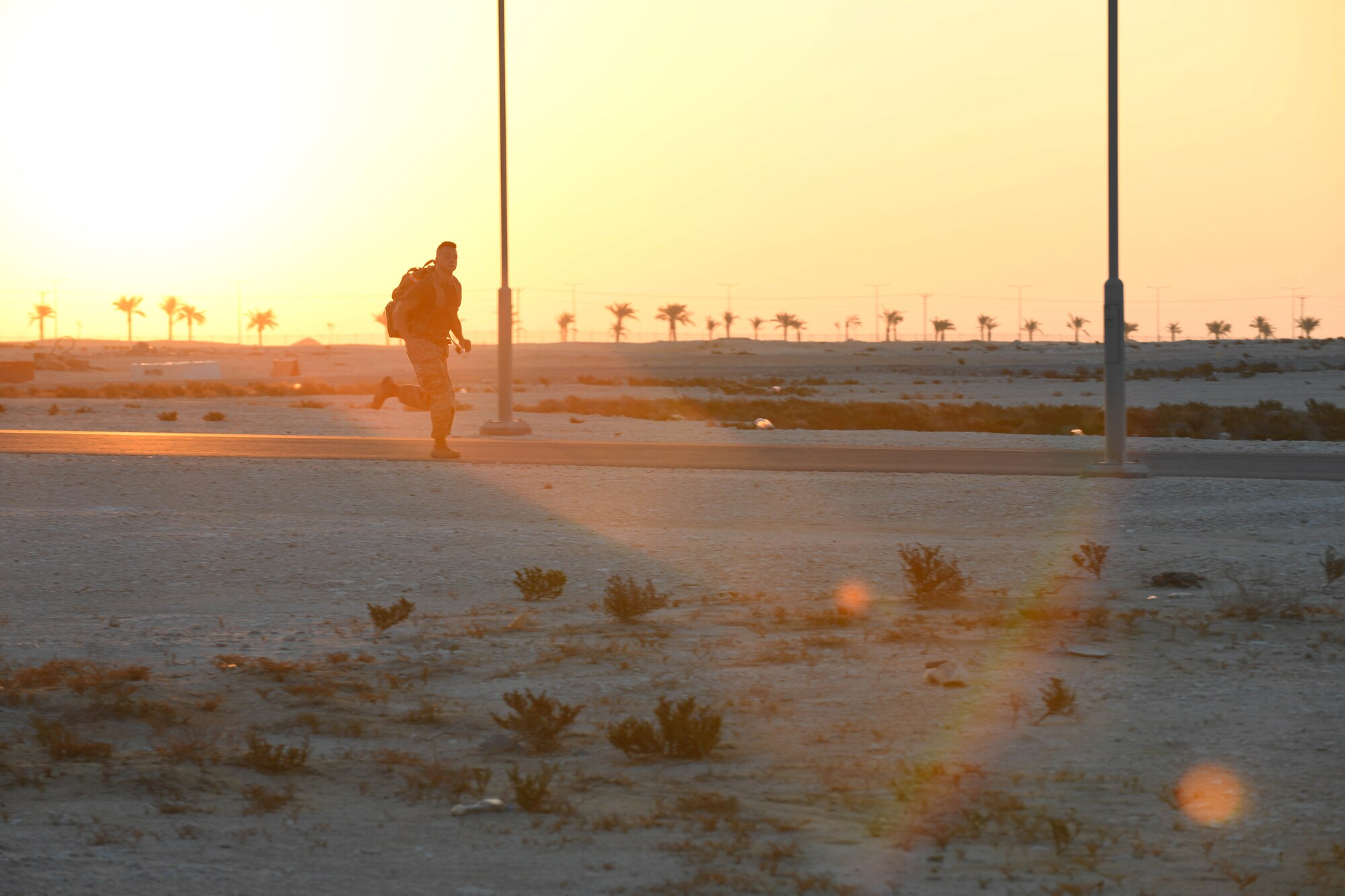 U.S. Army Private 1st Class Isaac Vieau, an ammunition supply specialist, 395th Ordnance Company, deployed to Al Udeid Air Base, Qatar, rucks through sunrise Dec. 5, 2020, while participating in the traditional 30-kilometer (18.6-mile) Norwegian foot march event. The tradition began in 1915, 10 years after Norway gained its independence from Sweden and has become a rite of passage for all Norwegian military members. Vieau was one of nearly 120 coalition members, including Americans, Australians, New Zealanders, British and Canadians who participated in the march under the supervision of Norwegian armed forces Capt. Magne Rambo, deployed to Al Udeid AB as part of the U.S. Central Command Partner Integration Enterprise. (U.S. Air Force photo by Staff Sgt. Kayla White)