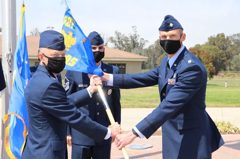 Col. Daniel Rickards, 381st Training Group commander, passes the 533rd Training Squadron guidon to Lt. Col. Charles Cooper, 533rd Training Squadron commander, during the 533rd TRS transfer to STAR Delta Provisional Sept. 3, 2020 at Vandenberg Air Force Base, Calif.